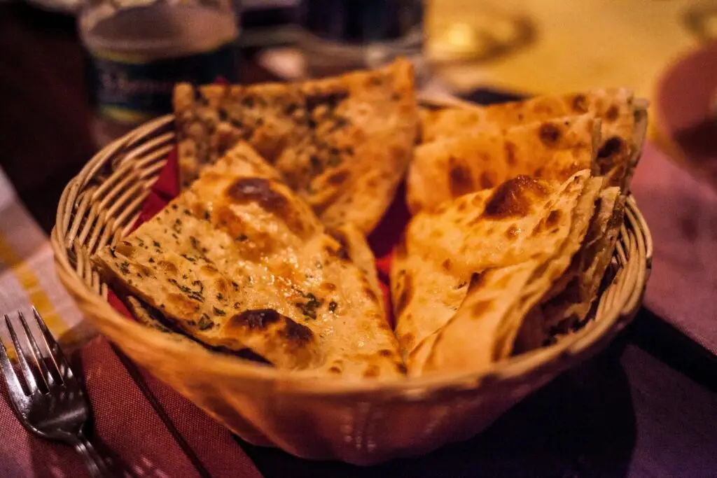 Close-up of traditional Indian flatbreads in a basket, perfect for a delicious meal.